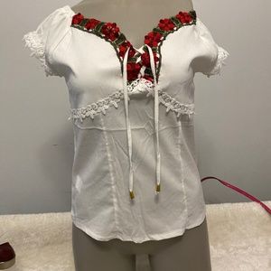 white t-shirt with very traditional flowers